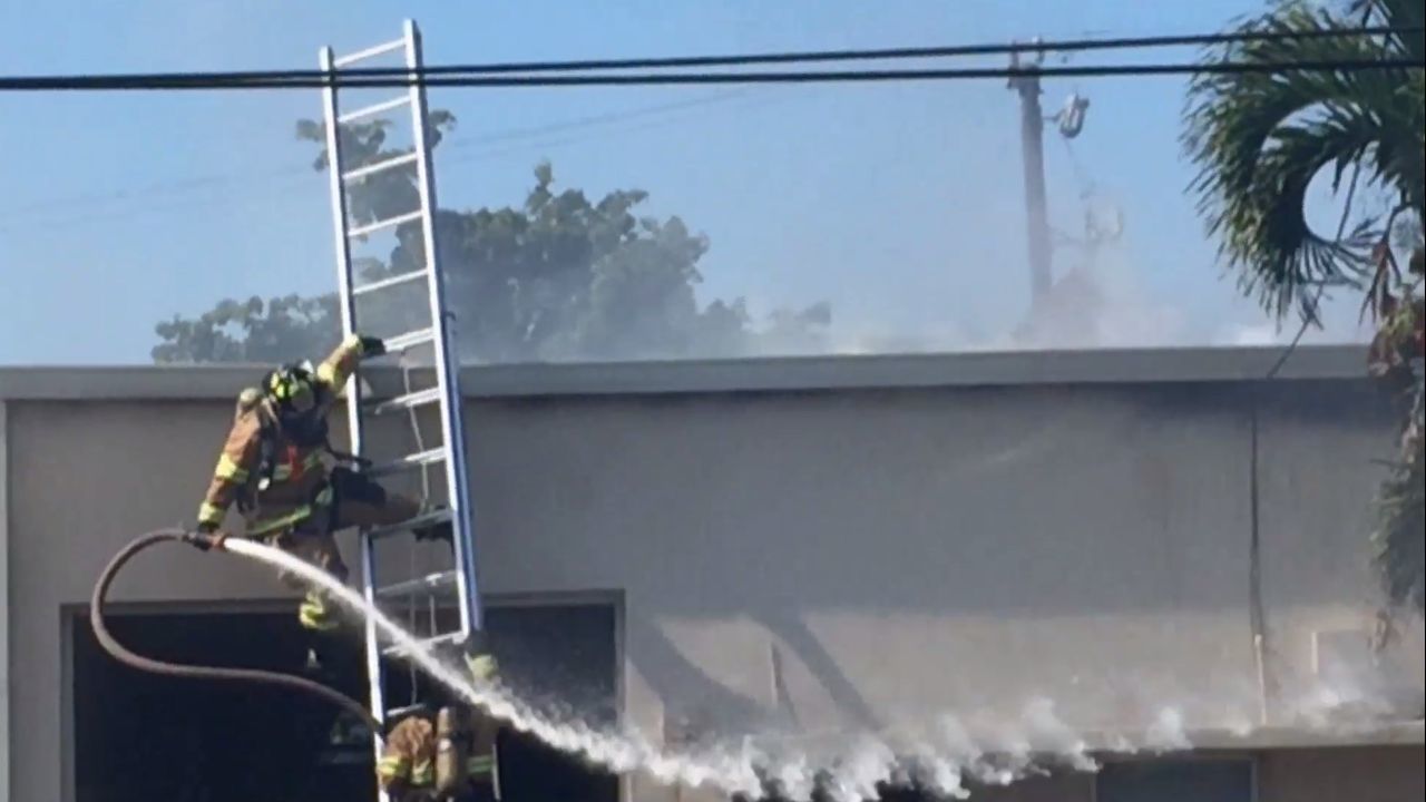 Firefighter falls from ladder while battling fire