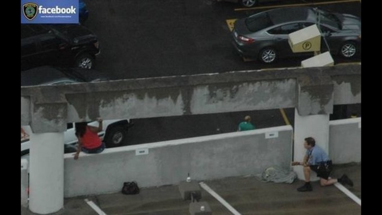HPD officer talks suicidal woman off parking garage ledge