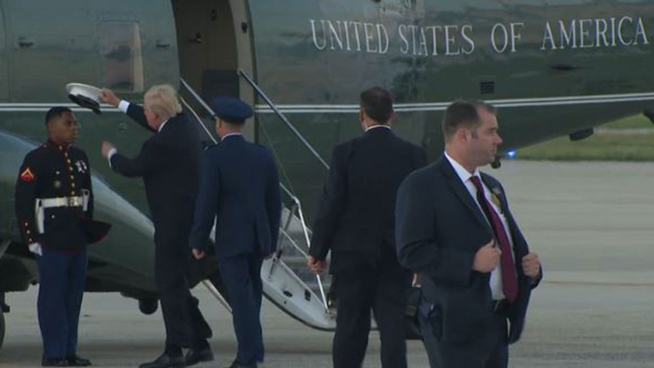 President Trump helps Marine with hat